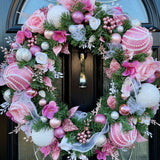 Luxury handmade artificial Christmas wreath in pink and white featuring large pink glitter and pearl baubles.