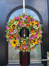Luxury late summer wreath featuring bright sunflowers, roses, and faux flowers in vibrant colors.