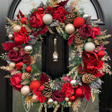 A stunning traditional red and gold 60cm christmas wreath. Handcrafted with rich and bright contrasting shades of red to add depth and beauty. Roses and peonies are offset with pinecones, baubles of varying sizes and gold accents throughout.