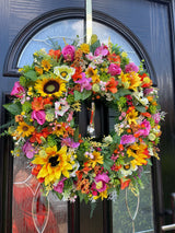 Luxury late summer wreath featuring bright sunflowers, roses, and faux flowers in vibrant colours, perfect for home decor.
