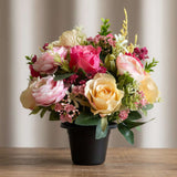 Luxury real look artificial grave pot flowers in pinks and yellows.