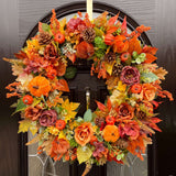 An extra large artificial autumn wreath with a realistic look, featuring a mix of burnt colors including oranges, yellows, and browns florals, foliage, pumpkins and berries