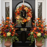 Decorative autumn wreath with pumpkins and flowers and matching planters.