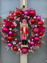 Large luxury pink and red Christmas wreath with nutcracker