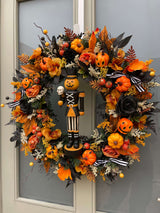 Luxury autumn wreath with Halloween pumpkin nutcracker