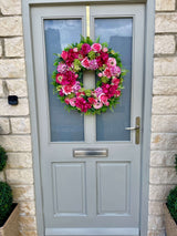 Full door view of extra large luxury artificial bright pink and green summer wreath
