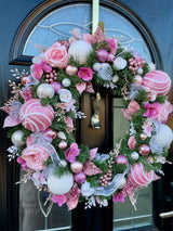 Oversized artificial Christmas wreath for front door in pink and white.