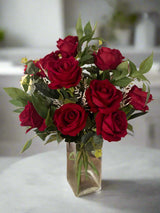 A luxury bouquet of large open artificial deep red velvet roses with habiki leaves and eucalyptus.