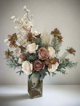An extra large artificial flower arrangement featuring muted tones of mocha, coffee and vanilla. Frilly cosmos, lambs ear and flocked leaves create the whimsical branch background to the vanilla and coffee roses in the centre.