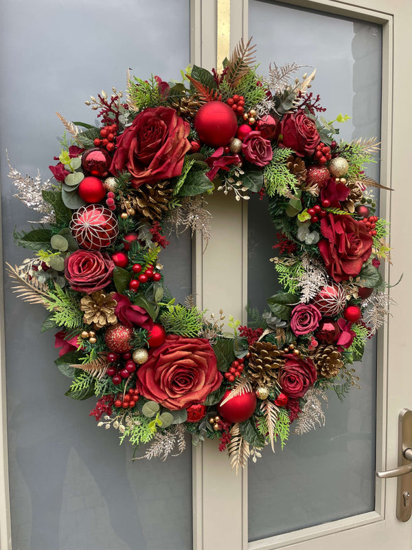 Extra Large rich red rose artificial Christmas Wreath New with roses, baubles, and festive greenery on a door.