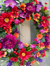 Luxury artificial bright summer wreath purple, red and orange