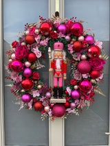 Large luxury pink and red Christmas wreath with nutcracker