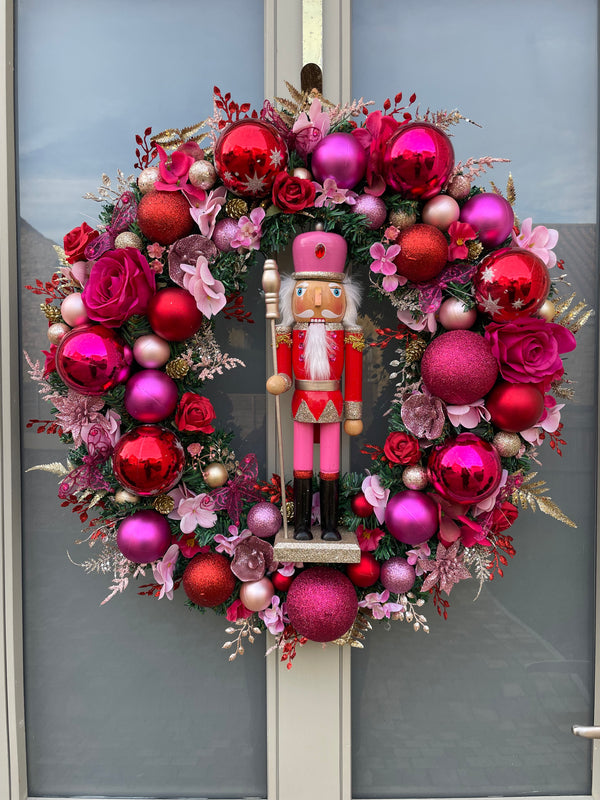 Large luxury pink and red Christmas wreath with nutcracker