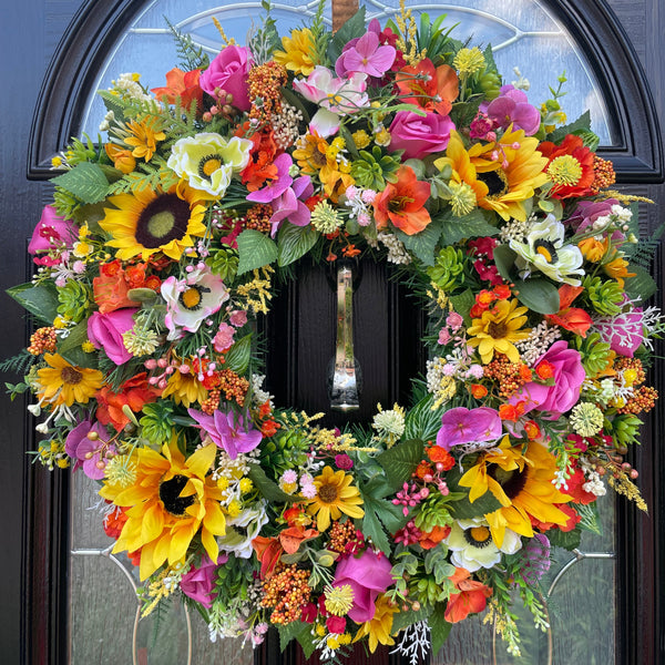 Bright multicolour yellow, orange and pink summer wreath with large sunflowers, roses, daisies, hydrangea and more