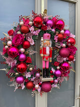 Large luxury pink and red Christmas wreath with nutcracker