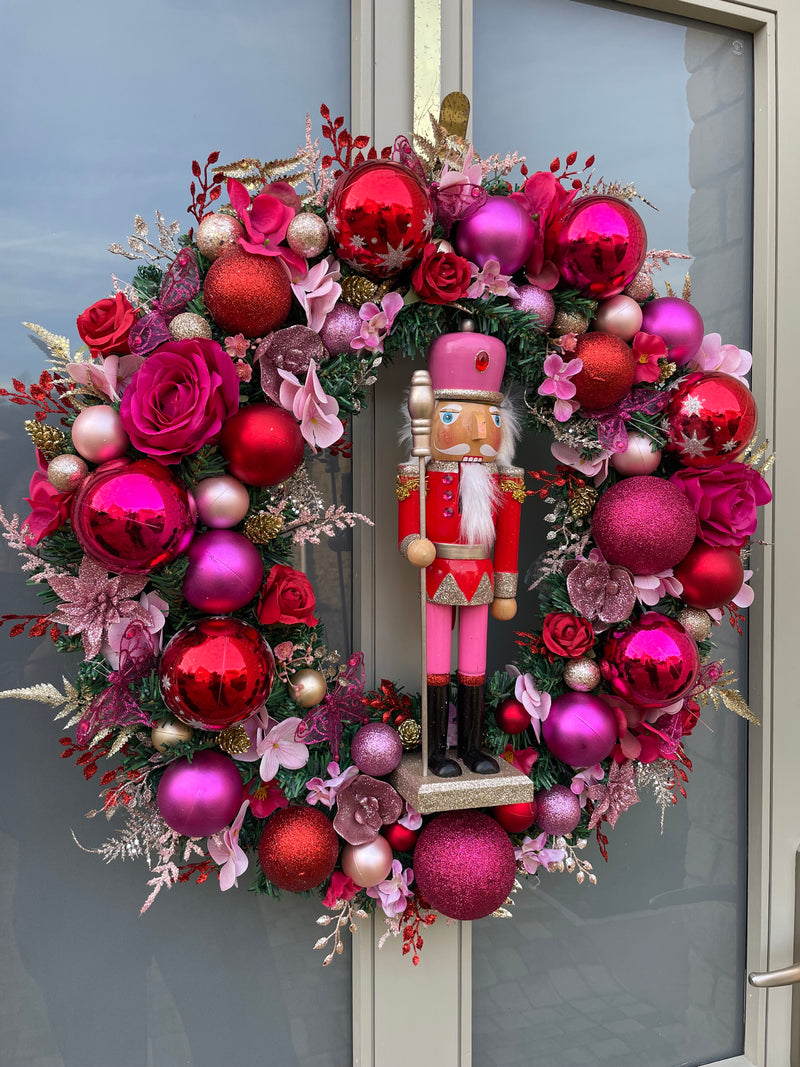 Large luxury pink and red Christmas wreath with nutcracker