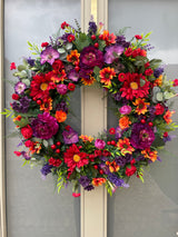 Luxury artificial bright summer wreath purple, red and orange