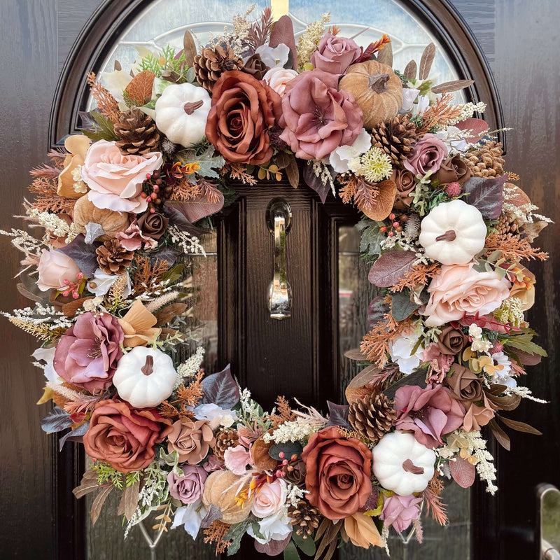 An extra large brown and cream autumn wreath with faux florals in browns and mochas with accents of cream pumpkins.