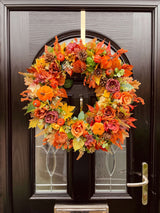Full door view of luxury artificial autumn pumpkin wreath with yellow and oranges with velvet pumpkins 