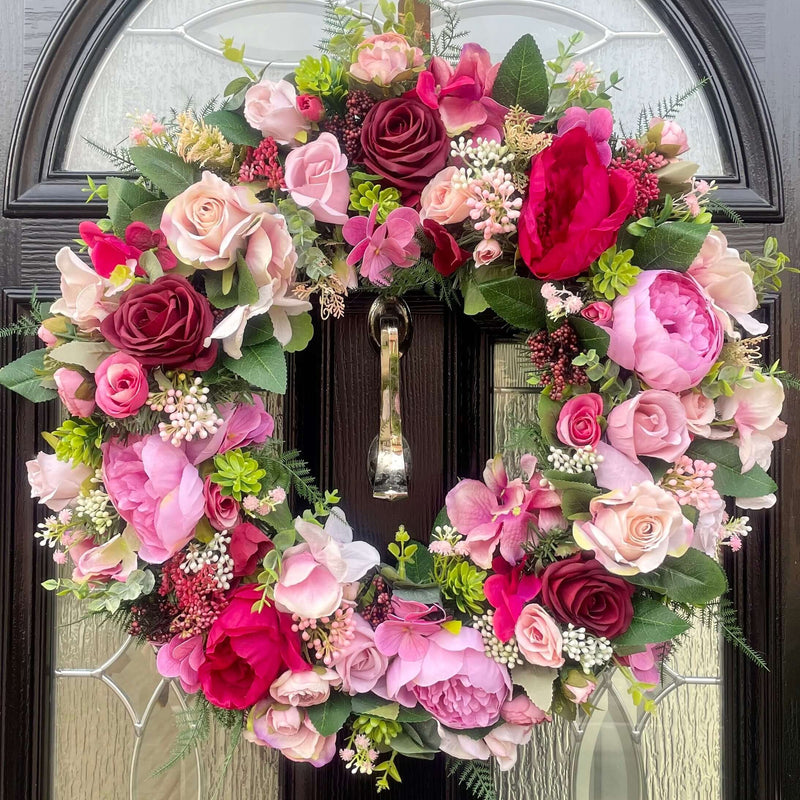 A mix of sizes and shades of pink roses and peonies, in luxury artificial silk. Mixed with hydrangea and berries and foliage for a striking pink look.