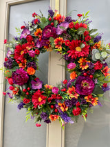 Luxury artificial bright summer wreath purple, red and orange