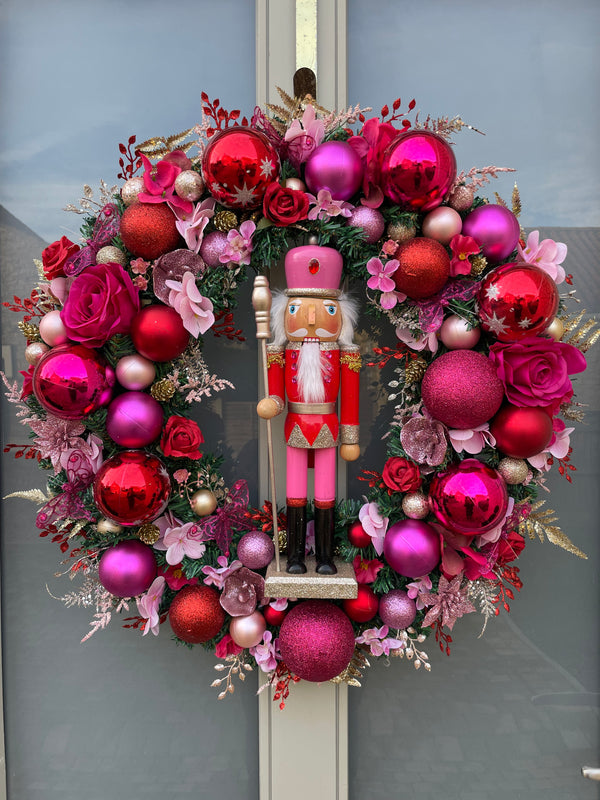 Large luxury pink and red Christmas wreath with nutcracker