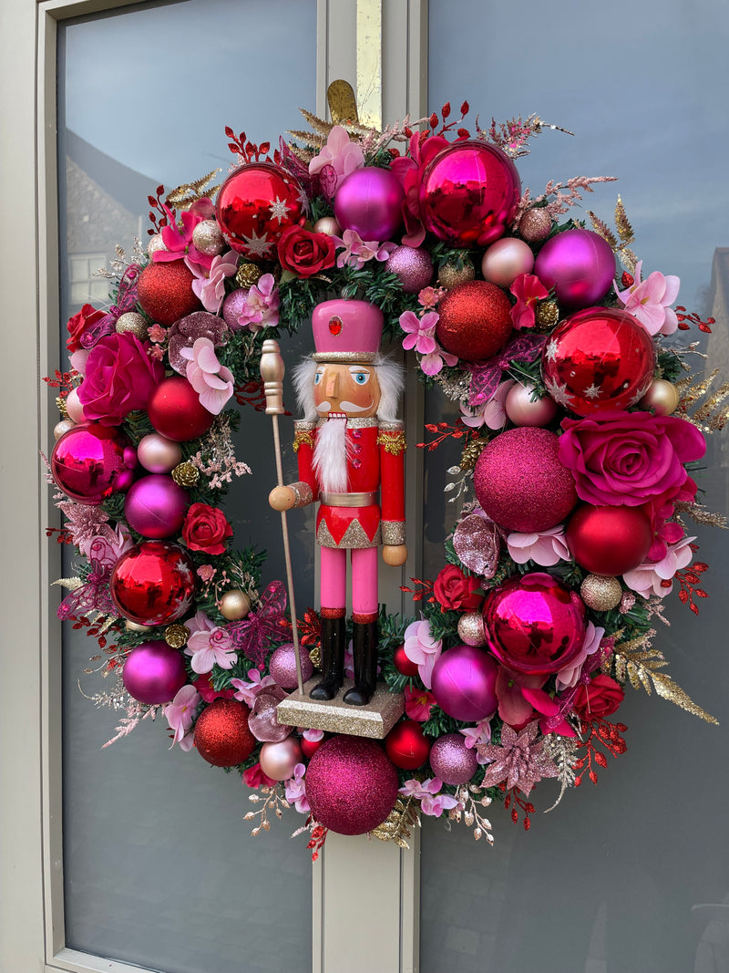 Large luxury pink and red Christmas wreath with nutcracker