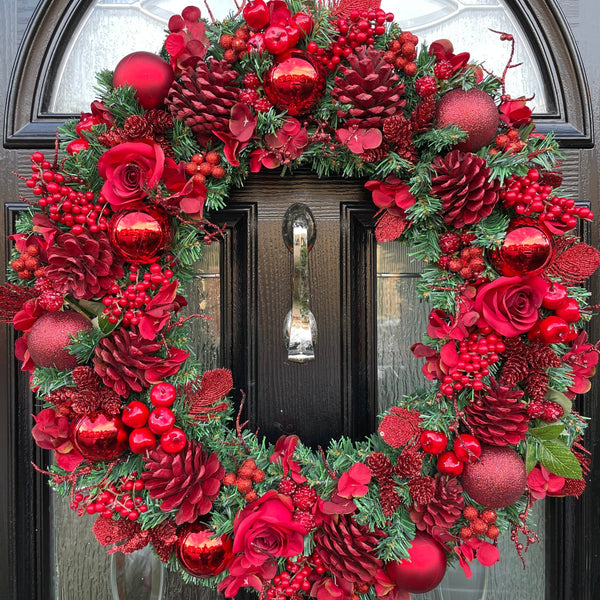 An extra large 60cm all red Christmas wreath. Red sprayed pinecones, red roses, red berries of varying varieties some with glitter, some frosted and some shiney. A real statement.