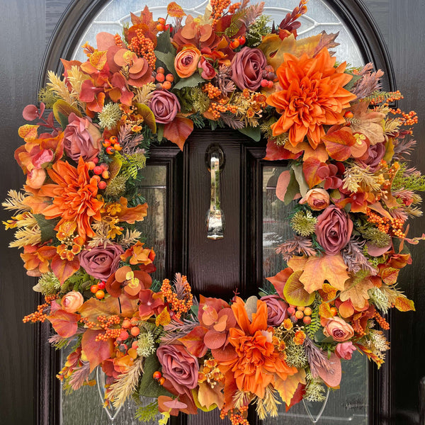 Large Autumn wreath full of luxury artificial flowers in shades of orange and brown 