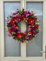 Luxury artificial bright summer wreath purple, red and orange