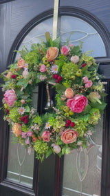 Large 60cm summer wreath with pink and peach florals, faux berries, and lush green backdrop, bright and high-quality handmade design.