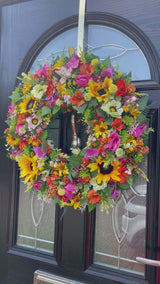 Luxury large sunflower summer wreath with bright colors, featuring faux flowers and foliage on a front door.