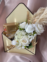 Artificial flower and chocolate envelope box gift arrangement