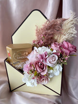 Artificial flower and chocolate envelope box gift arrangement